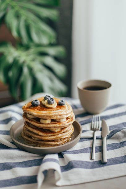 Stack of blueberry pancakes with coffee
