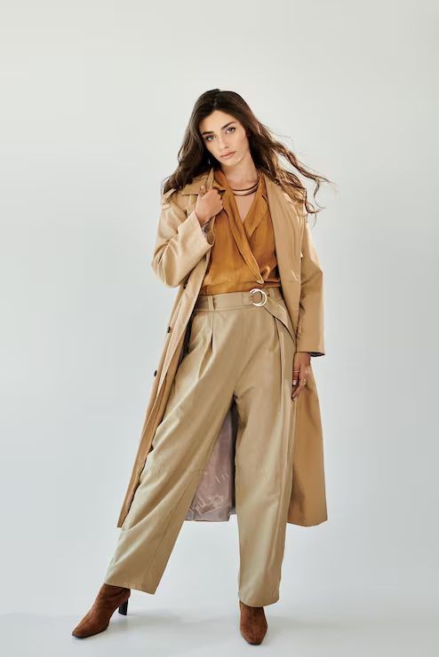 Model wearing an oversized beige trench coat